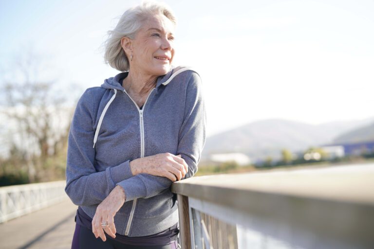 Portrait of attractive senior woman in sportswear outdoors